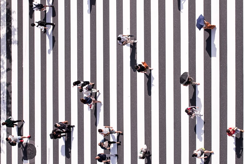 people crossing a city street